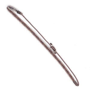 Close-up of woven bohemian bracelet with geometric pattern and adjustable knot
