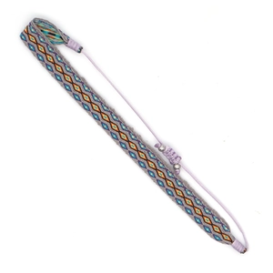 Detail of bohemian hand-woven bracelet with grey base and colorful diamond patterns