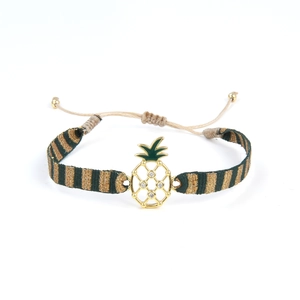 Détail du bracelet tressé avec pendentif ananas doré et incrustation d'émail vert et strass