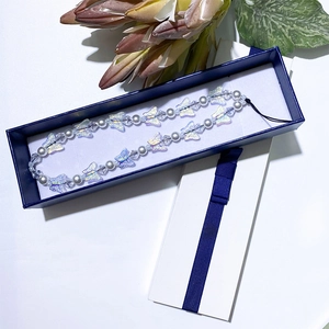 Iridescent butterfly beaded phone charm with white pearls in a blue gift box