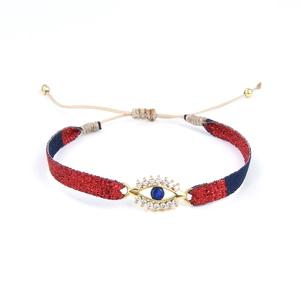Bracelet œil porte-bonheur tressé de style ethnique avec pierre bleue et zircons dorés