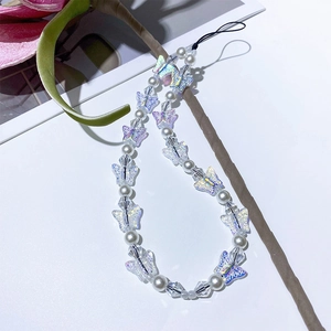 Iridescent butterfly beaded phone charm with white pearls and acrylic beads on white background