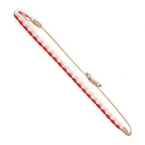Close-up of bohemian woven bracelet with red wave patterns and adjustable metal slider