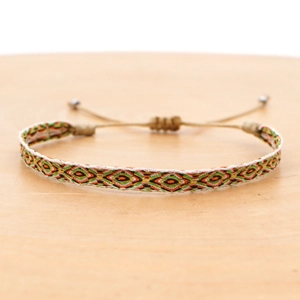 Detail of bohemian woven bracelet with geometric patterns and adjustable closure
