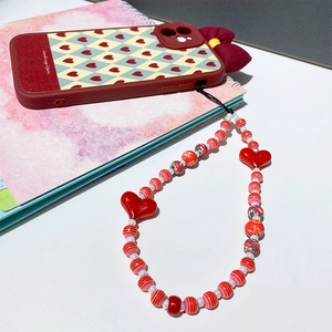 Handmade beaded phone strap with red heart charms and matching checkered silicone case