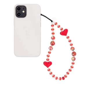 Handmade beaded phone strap with red heart charms and floral beads on a white smartphone
