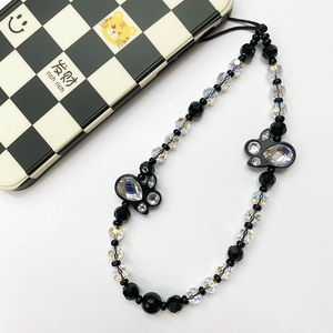 Detailed view of handmade phone charm with black beads, AB crystals and butterfly charms
