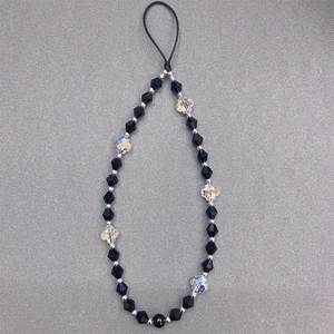 Detail of beaded phone strap with black faceted beads and clear clover crystal