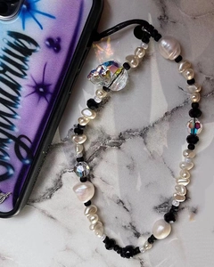 Detail of beaded phone strap with white baroque pearls and a colorful crystal heart