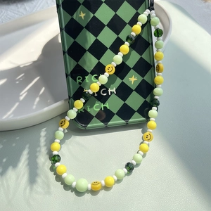 Handmade beaded phone strap with mint green beads and yellow smiley face charms
