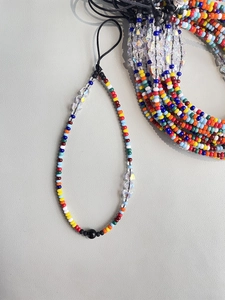 Close-up of handmade colorful seed beads and transparent crystal charms for phone strap