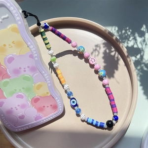 Colorful bohemian clay bead phone strap with evil eye and smiley face charms