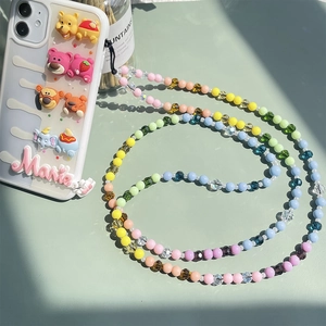 Detail of colorful beaded phone strap with 3D resin cartoon character decorations