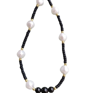 Minimalist black matte beads and white baroque pearl necklace with golden metal accents