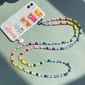 Detail of transparent phone case with 3D resin cartoon characters and colorful beaded strap