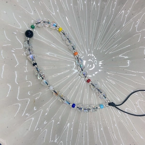 Colorful handmade acrylic beaded phone charm with multi-color beads on a white tray