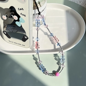 Detail view of handmade beaded phone strap with colorful heart beads and matte pink orb
