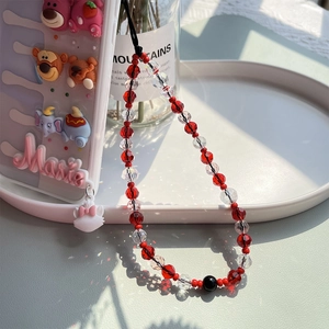 Detailed shot of beaded phone lanyard with 3D cartoon strawberry bear and Marie cat