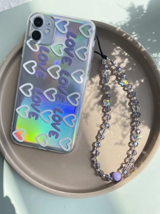 Detail of laser iridescent phone case with LOVE text and purple crystal butterfly charm