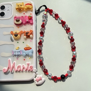 Detail of white 3D cartoon phone case with red beaded strap and Marie cat pendant