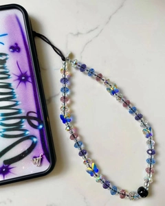 Detail of handmade beaded phone strap with crystal beads and butterfly charms on purple case