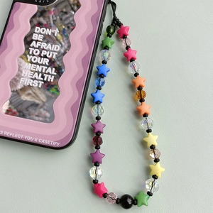 Colorful beaded phone strap with matte stars and faceted crystals on a phone case