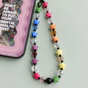Close-up of star-shaped resin beads phone strap with faceted crystals on leather