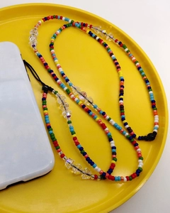 Colorful handmade seed bead phone lanyard with faceted crystals on a yellow tray