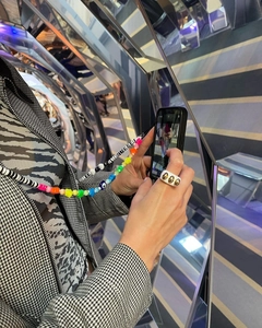 Detail of colorful bohemian beaded phone strap with evil eye beads and mirror reflection