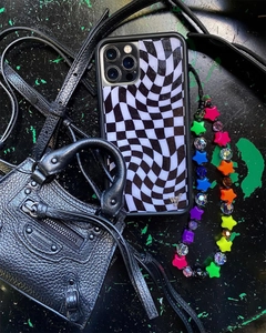 Black and white checkered phone case with colorful star beaded wrist strap on a leather bag