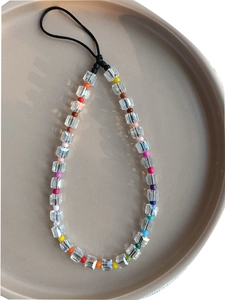 Detail of colorful faceted crystal beads and rainbow glass seed beads on a phone charm
