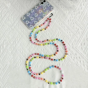Rainbow gradient beaded crossbody phone strap with evil eye beads on heart case