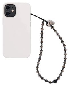 Detail view of dark grey faceted beads and crystal skull pendant on phone wrist strap