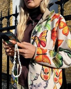 Detail showing white pearls and clear crystal beads on a stylish phone wrist strap