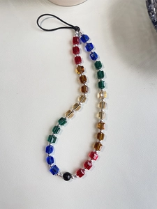 Close-up of colorful faceted crystal beads with silver spacers on a trendy phone strap