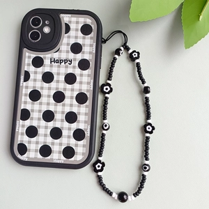 Close-up of handmade beaded phone strap with black floral charms and checkered case