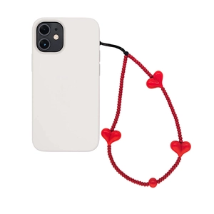 Handmade red beaded phone charm strap with heart accents on a white smartphone