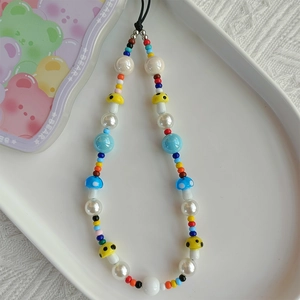 Close-up of colorful acrylic beaded phone strap featuring cute resin mushroom charms