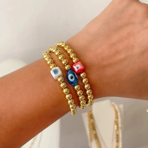 Three-piece set of 18k gold plated evil eye beaded bracelets with colorful charms