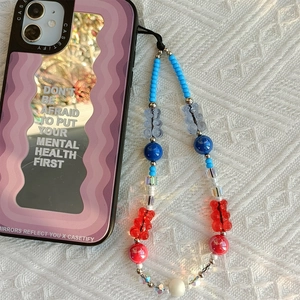 Detail of beaded phone strap with colorful gummy bears and crystals on a mirror phone case