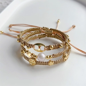 Handmade woven bracelet set with golden star charms, smiley face pendant and white pearl
