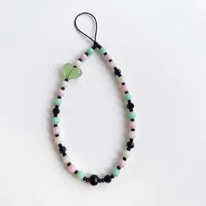 Handmade beaded phone strap with pink, green, and cream beads and a heart pendant