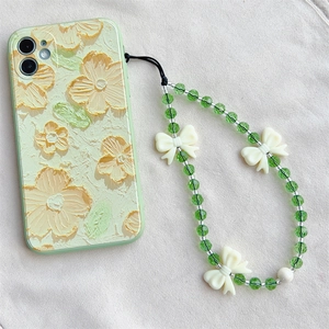 Light green floral phone case with crystal beaded lanyard and white bow accents