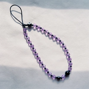 Bohemian purple beaded phone strap featuring black evil eye charms and faceted crystals