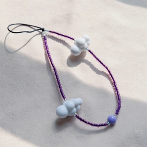 Purple beaded phone strap with white cloud charms and translucent beads in a modern style