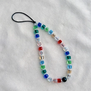 Detail of colorful transparent cubic crystal beads on a mobile phone lanyard strap