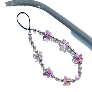 Elegant beaded phone strap with iridescent purple butterflies and grey beads on white background