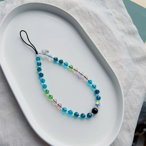 Colorful ocean style crystal bead phone charm strap with skull bead on ceramic tray