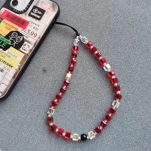Handmade phone strap with red and iridescent square crystal beads and black cord accents