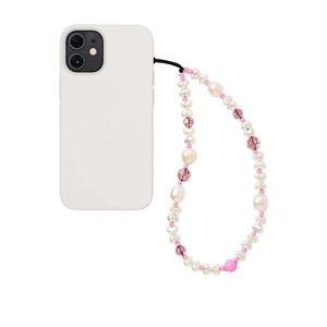 Detail of irregular white pearls and pink crystal beads on a phone charm with white case